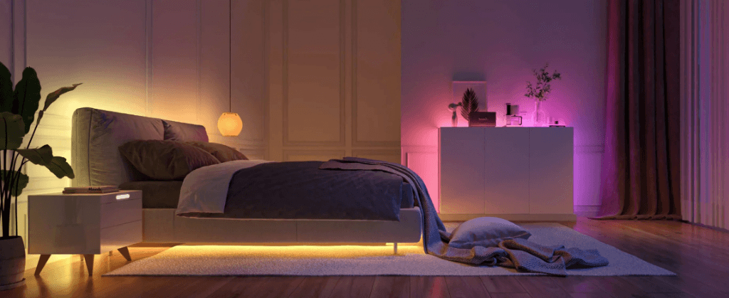 Modern bedroom with warm ambient lighting from LED strips and smart bulbs creating a relaxing atmosphere